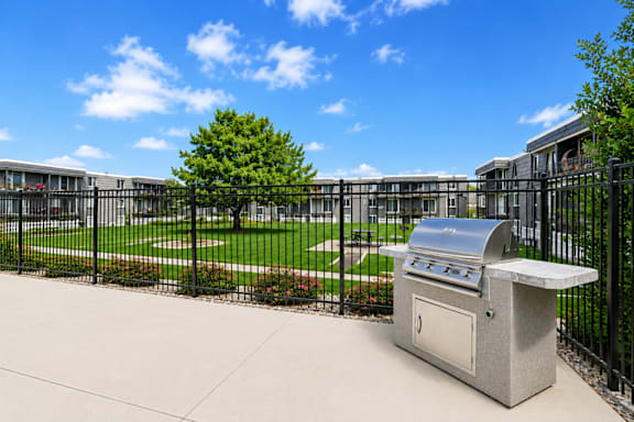 Outdoor grilling with black fence and courtyard view at Park Station Apartments, Midvale, Utah