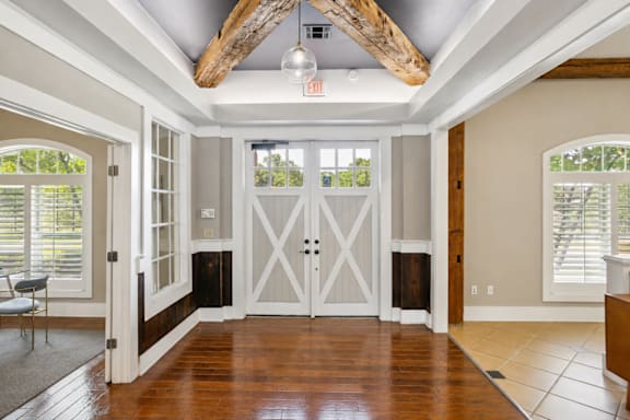 A room with a wooden floor and a white door.