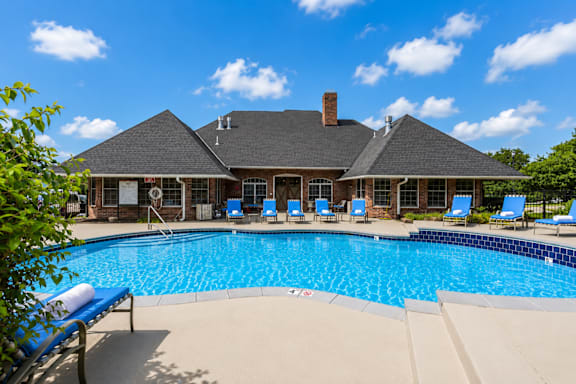 A large house with a pool in front.