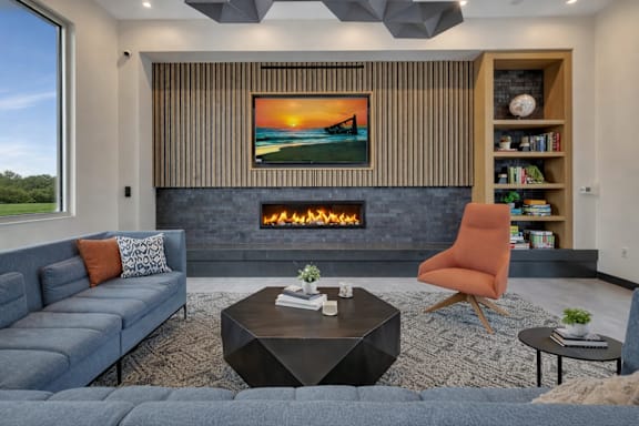 Living room with fireplace and entertainment center at Prosper West Apartments, Waite Park
