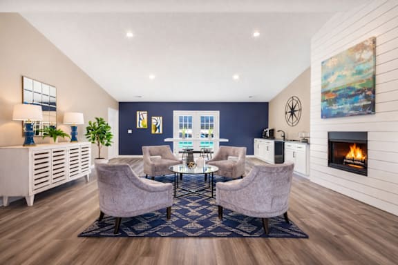 A living room with a fireplace and a blue rug.