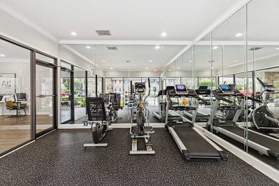 A gym with treadmills and exercise equipment.