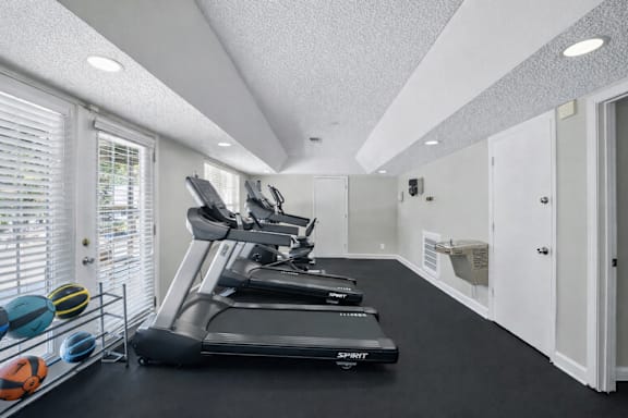 A treadmill is on the left side of the room.