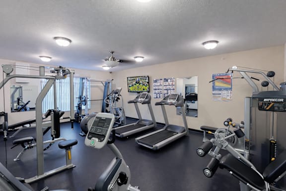 Fitness center with treadmills and weight machines at The Ponds at Heritage Place Apartments, Minnesota
