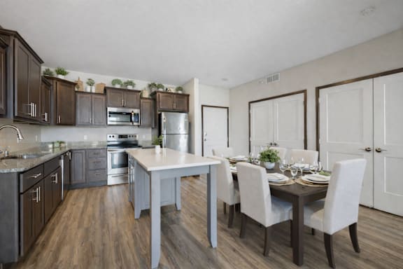 A modern kitchen with dark wood cabinets and a white island.