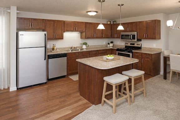 A kitchen with wooden cabinets and a white refrigerator.