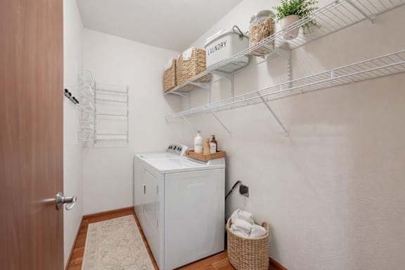 A small laundry room with a washer and dryer.