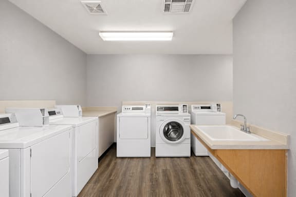 A laundry room with washers and dryers.