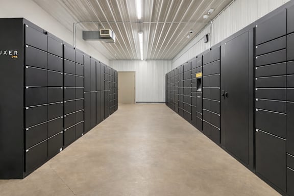 Secure package locker room with modern storage units at Prosper West Apartments, Waite Park, Minnesota