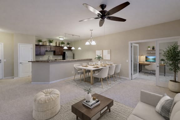 A modern open plan living and dining area with a kitchen in the background.