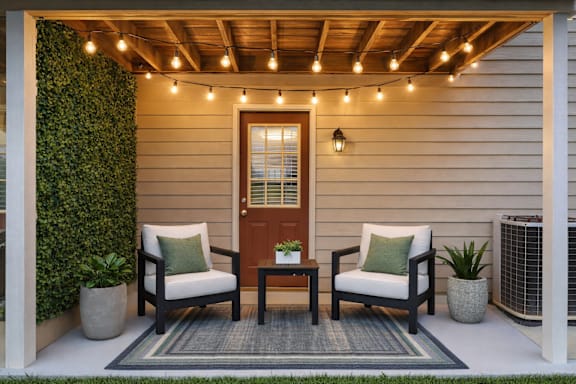 A cozy outdoor seating area with a wooden table and chairs.