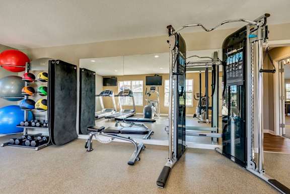 Well equipped fitness center with cable machines at Creekview Apartments, Utah