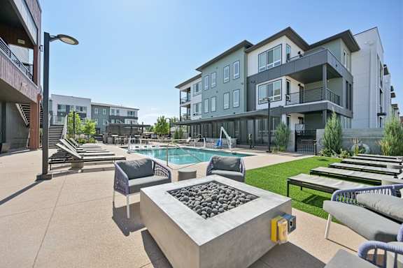 Outdoor courtyard with swimming pool and fire pit at Sequel Homes Apartments, Colorado