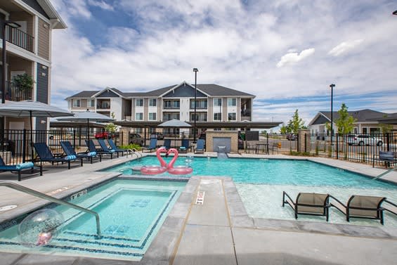 swimming pool with lounge chairs and umbrellas at Connect First Creek, Denver CO