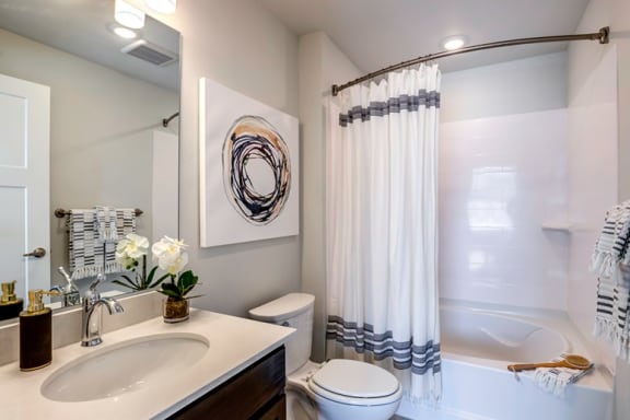 bathroom with bathtub and tile at Connect at First Creek Denver, 80249