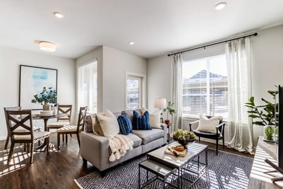 living room with a couch plank flooring at Connect at First Creek, Colorado 80249
