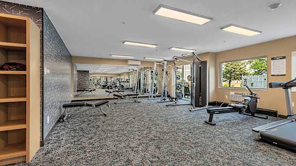 Fitness center with weight machines and workout equipment at Grand Gateway Apartments, St Cloud, MN