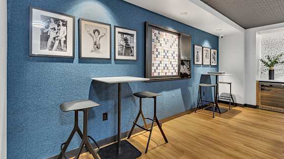 Cafe seating area with framed art display at Grand Gateway Apartments, St Cloud, Minnesota