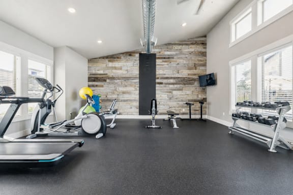 Fitness center with wood accent wall at Harper Ridge Apartments, Meridian, ID