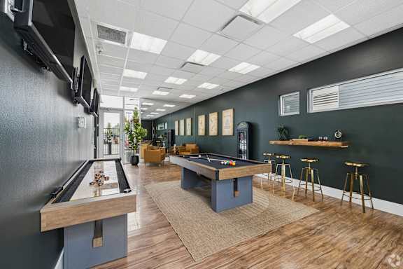 Entertainment lounge with billiards and bar seating at Lofts at Innovation Center Apartments, Washington, 99354