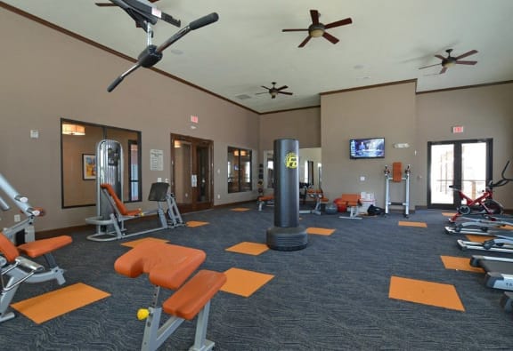 a gym with weights and other exercise equipment in a large room