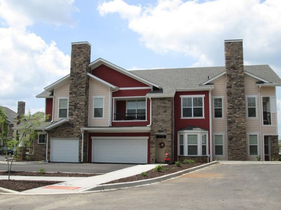 a large house with two chimneys on the side of a street
