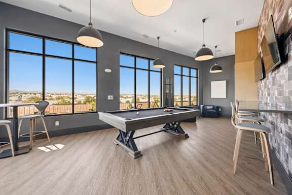 Recreation room with billiards table and lounge seating at Sequel Homes Apartments, Englewood