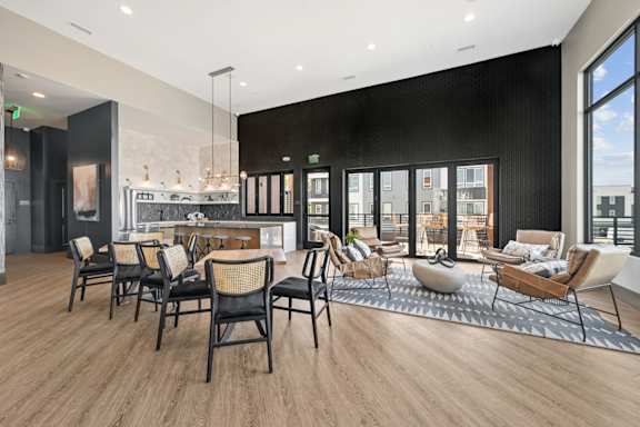 Community lounge with dining tables and seating areas at Sequel Homes Apartments, Colorado