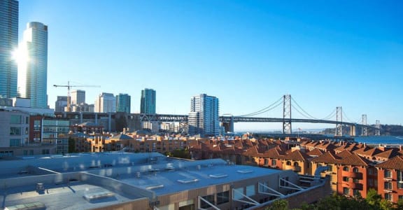 a view of the city and the bay bridge from the roof of a building