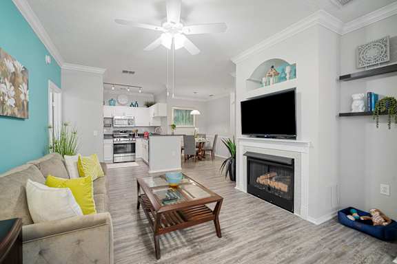 living room with sofa, coffee table and fireplace