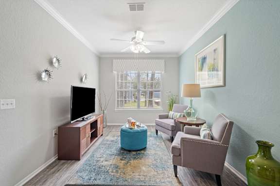 Living room with chairs and ottoman