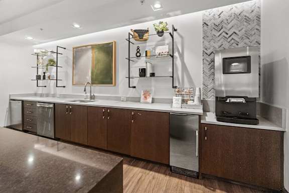 A modern kitchen with dark wood cabinets and stainless steel appliances at 1010 Dilworth Apartments, Charlotte 28204