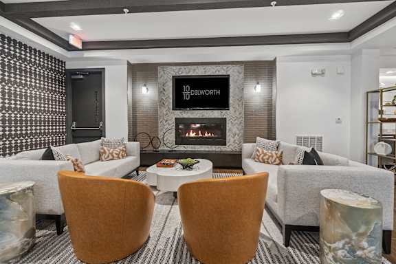 A modern sitting room with a fireplace and a flatscreen TV at 1010 Dilworth Apartments, Charlotte, NC
