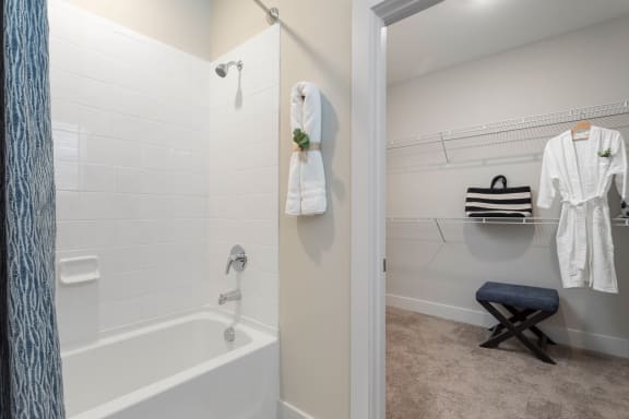 a bathroom with a tub and a shower and a towel rack at Bristol at New Riverside, Bluffton, SC