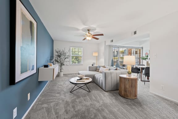 a living room with a couch and a ceiling fan  at Courthouse Square Apartments, Towson, MD, 21286