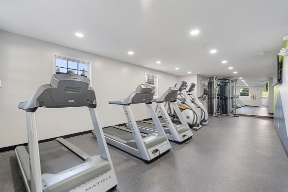 a row of treadmills in a gym with cardio equipment at Courthouse Square Apartments, Towson