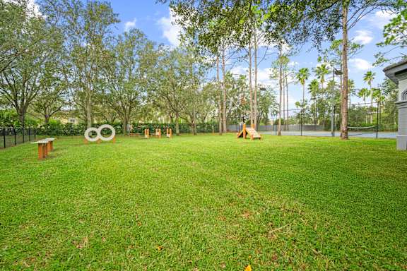 A park with a grassy area and a large sculpture in the middle.