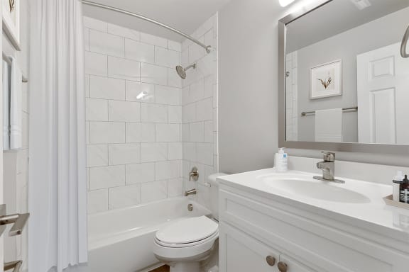 a bathroom with a bathtub and a sink Kenilworth at Perring Park Apartments, Parkville, MD 21234