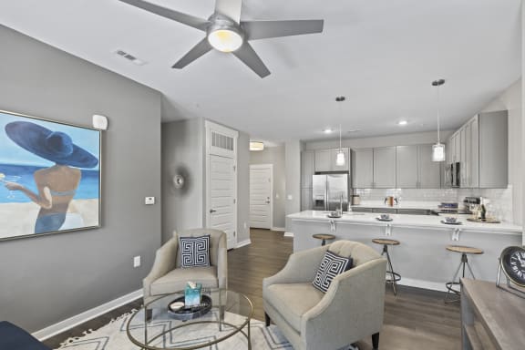 an open living room and kitchen with a ceiling fan at Central Island Square, Daniel Island, SC, 29492