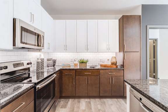 a modern kitchen with stainless steel appliances at Dartmoor Place at Oxford Square Apartments, Hanover, MD