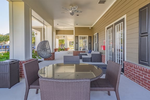 a patio with a table and chairs and a ceiling fan at Fortress Grove, Murfreesboro, Tennessee