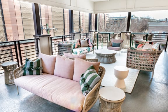 a rooftop seating area with couches and tables at Park and Kingston, Charlotte, NC