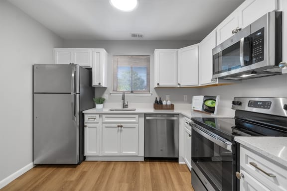 a kitchen with stainless steel appliances and white cabinets at Westwinds Apartments, Annapolis, Maryland