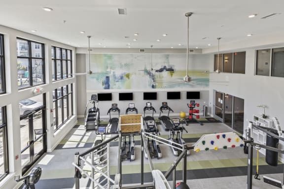 the lobby of a gym with chairs and a large wall of windows at Central Island Square, South Carolina
