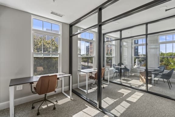 a conference room with glass doors and windows and desks at Central Island Square, South Carolina, 29492