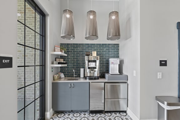 a kitchen with blue cabinets and a coffee maker on the counter at Central Island Square, Daniel Island, 29492