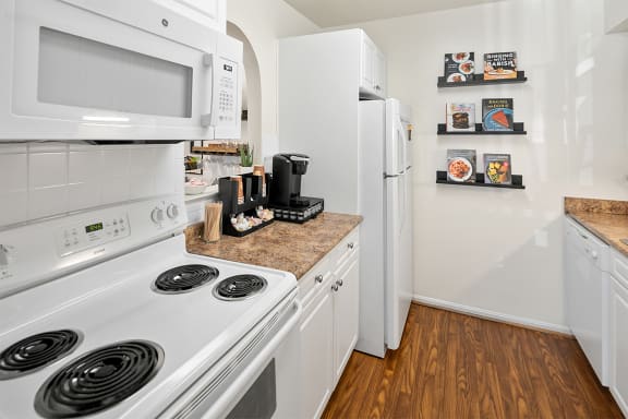 a kitchen with white appliances and a white refrigerator at McDonogh Township Apartments, Maryland
