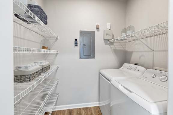 A laundry room with a washer and dryer and a door at Sweetgrass Landing, Mount Pleasant, South Carolina, 29466
