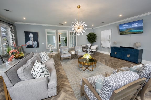 a living room with couches and chairs and a tv