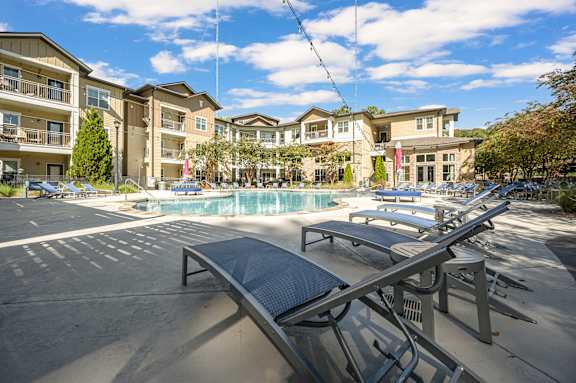 A sunny day at the outdoor pool area of a residential complex.